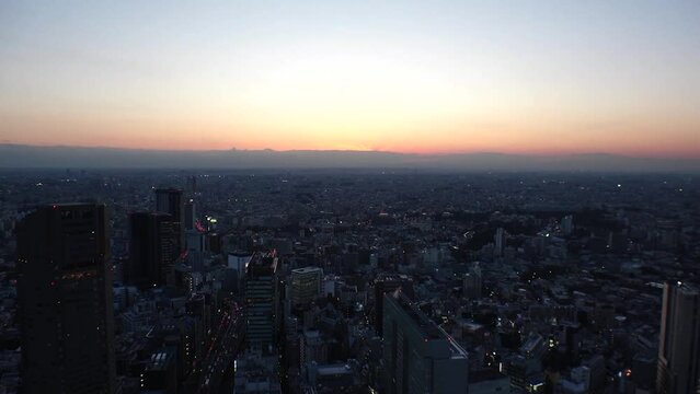 TOKYO, JAPAN : Aerial high angle sunset view of CITYSCAPE of TOKYO. Buildings and street around Shibuya station. Japanese urban city life, metropolis and travel concept. Time lapse shot, dusk to night