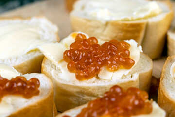Thinly sliced baguette with salmon caviar and butter
