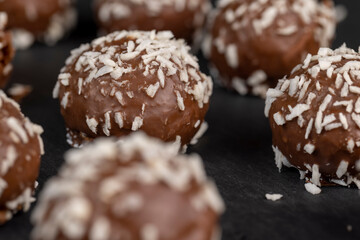 Chocolate candies in the form of balls with milk coconut