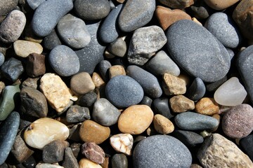 Stones of different sizes on the beach. Background texture.