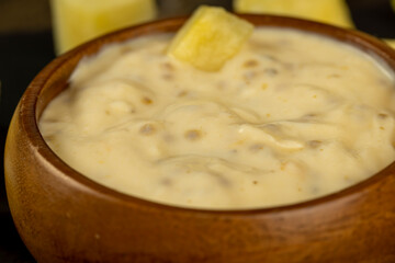 milk pineapple yogurt with pieces of pineapple and other fruits