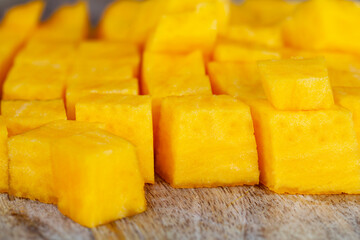Sweet ripe orange pumpkin is sliced on the table