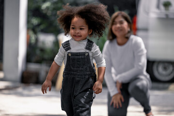 Toddler learn and grow every day with guidance and support of parents as she practice grasping objects and developing walking, running skills. Parents take care of physical, emotional needs of kid.