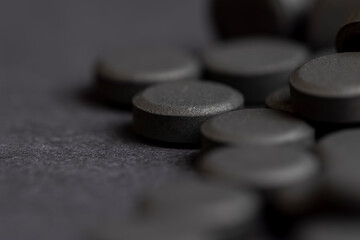 Open and unpacked tablets of black color close-up
