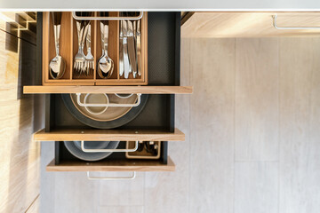 Kitchen drawers with stainless steel cutlery and dish
