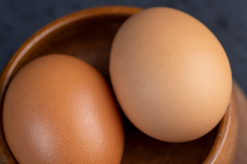 A whole orange chicken egg close-up on the table