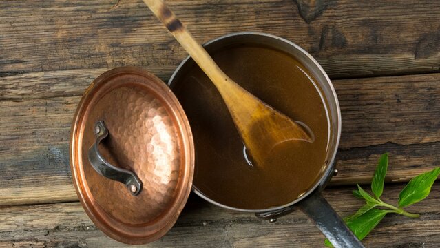 Culinary Artistry: Top-View Close-up of Rich Gravy in a Copper Pot in 4k