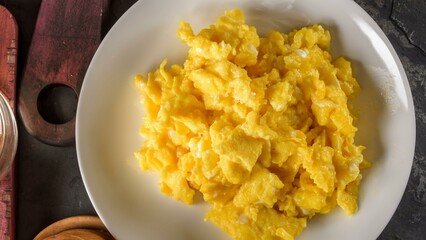 Morning Perfection: Intimate Close-up of Fluffy Scrambled Eggs in a white plate 