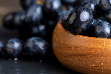 sweet ripe black grapes covered with drops of water