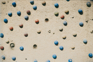 Climbing wall with blue and red balls, closeup 