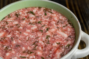 a bowl of traditional red beet borscht with sour cream and dill