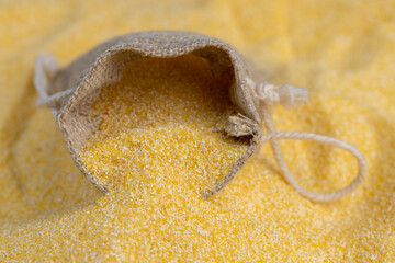 Linen bag of small size with dry corn flour for cooking porridge