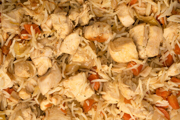Tasty pilaf with chicken as background.