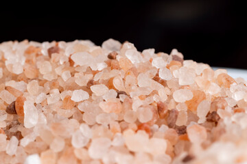 A large number of pink salt crystals of different sizes