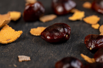 brown tamarind seeds on the table, scattered seeds