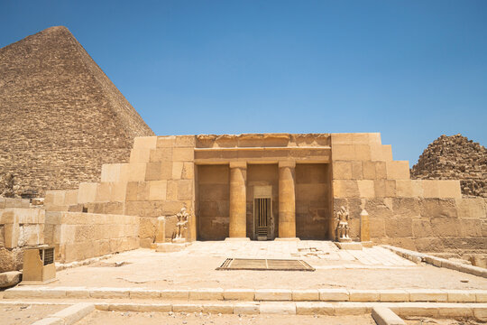 entrance of the mastaba of Seshemnufer IV late 5th Dynasty and the Great Pyramid in background. The Pyramid Fields from Giza to Dahshur is on UNESCO World Heritage List