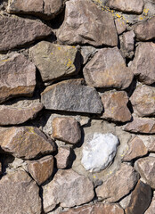 part of an old fence made of a large number of stones