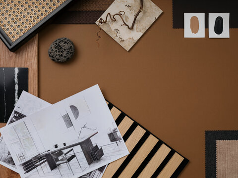 Stylish flat lay composition in brown, gray and beige color palette with textile and paint samples, lamella panels and tiles. Architect and interior designer moodboard. Top view. Copy space.