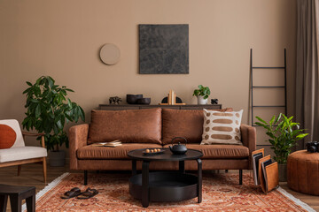 Stylish composition of living room interior with mock up poster frame, brown sofa, wooden...