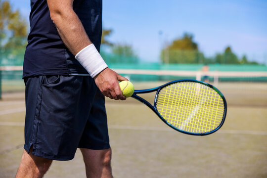 tennis player with racket and ball in hands ready to play at outdoor court