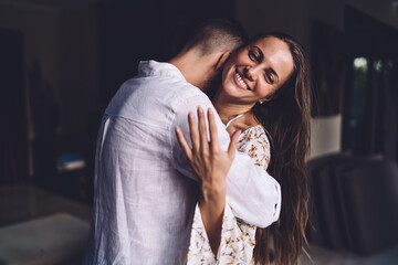 Cheerful female with sincerely smile on face feeling loved during positive weekend spending with...