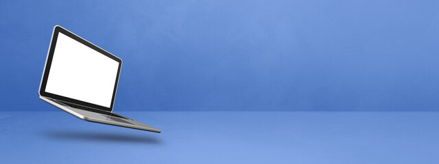 Floating computer laptop isolated on blue. Horizontal banner background