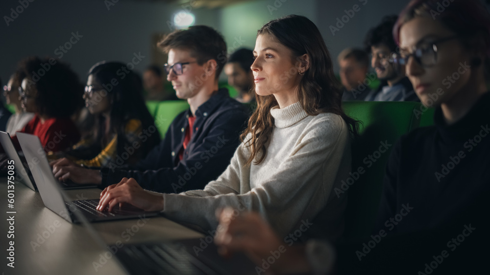 Poster Beautiful Smart Female Student Studying in University with Diverse Multiethnic Classmates. She is Using a Laptop Computer. Applying Her Knowledge to Acquire Academic Skills in Class
