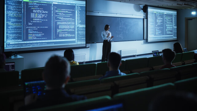 Diverse Multicultural Students Studying in University Room, Listening to a Young Female Professor Explaining Big Data and Artificial Intelligence Research Project. Computer Science Education