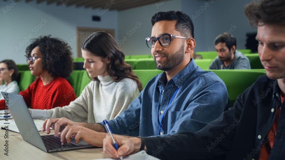 Poster Smart Handsome Male Student Studying in University with Diverse Multiethnic Classmates. Young Man is Using a Laptop Computer to Summarize the Lecture, Study at Home and Pass the Exams