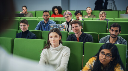 Diverse Multicultural Students Studying in University Room, Listening to a Professor Giving a...