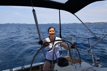 Woman at the helm of Croatia sailboat