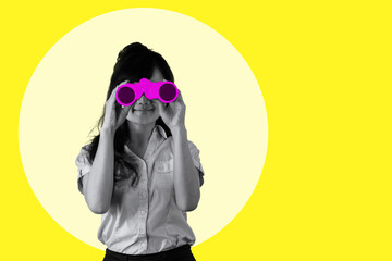 smiling young business woman looking through binoculars on yellow background