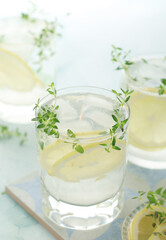Obraz na płótnie Canvas Glasses with lemon and thyme refreshing drink