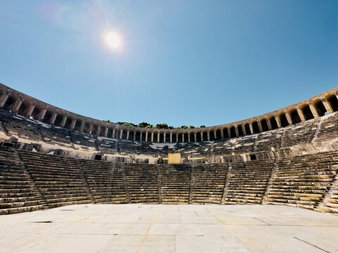 Wide-angle shot of Aspendos ancient theater, capturing the stage and audience stairs, displaying the grandeur of this historic site.