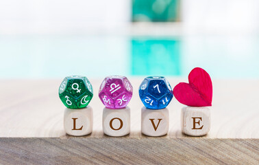 Dice divination on love wooden cube with red heart over blurred background, astrology dice fortune...