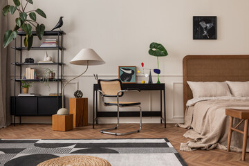 Creative composition of room interior with mock up poster frame, black desk, cozy bed, rattan...