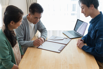 書類にサインを書く日本人男性