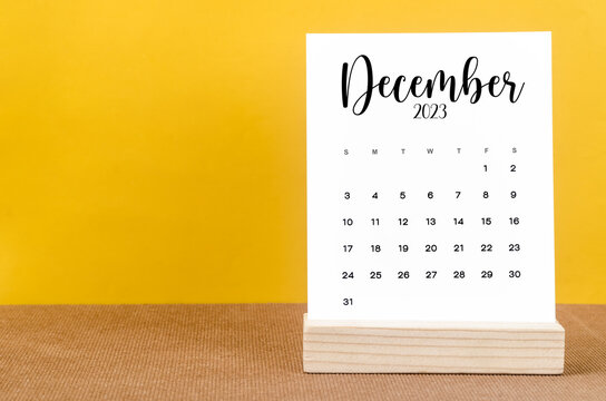 The December 2023 Monthly calendar for 2023 year on yellow table.
