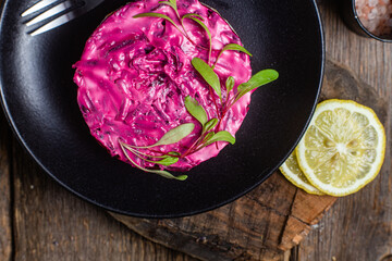 Salad with beets and salmon in a bowl. Salad Shuba