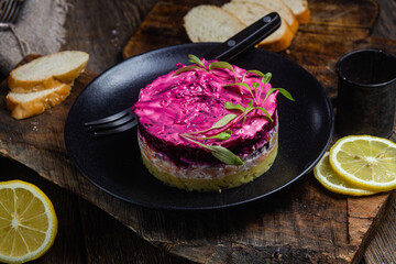 Salad with beets and salmon in a bowl. Salad Shuba