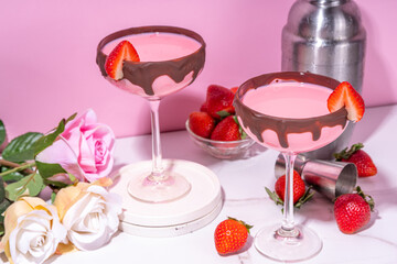Sweet chocolate strawberry cocktail, cute pink strawberry martini or daiquiri creamy drink, with fresh strawberry garnish and choco drizzles, on high-colored pink background