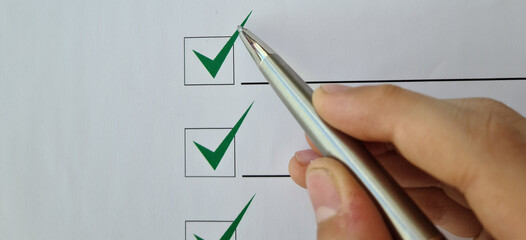 Silver ballpoint pen to cross off items from checklist