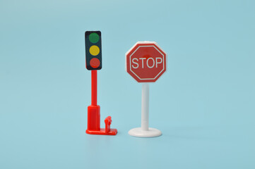 A large stop sign looms through the fog, as red traffic lights glow in the distance, emphasizing...