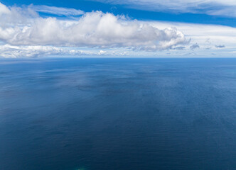 Naklejka na ściany i meble Blue sky with clouds over sea. Open blue ocean. Indonesia.