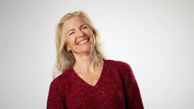 Portrait of fashionable laughing happy beautiful mature woman isolated on solid white background. Concept of beauty is ageless.