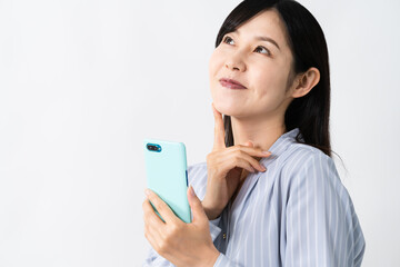 スマートフォンを持ちながら考える若い女性