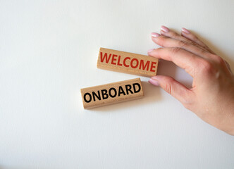 Welcome onboard symbol. Concept words Welcome onboard on wooden blocks. Beautiful white background. Businessman hand. Business and Welcome onboard concept. Copy space.