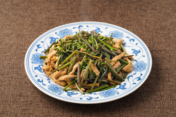 Stir-fried meat with mountain bracken on a monochrome background
