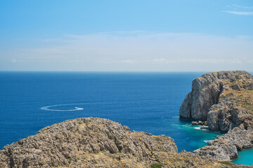 View from Lindos acropolis to St. Paul's bay and mediterranean sea, clear blue sky and emerald sea on the island of Rhodes, a famous place for holidays and travel around the islands