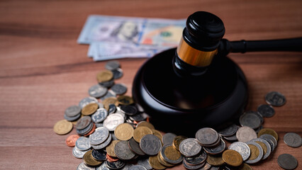 The gavel on a dollar bill in a courtroom represents the complex interplay between alimony law,...